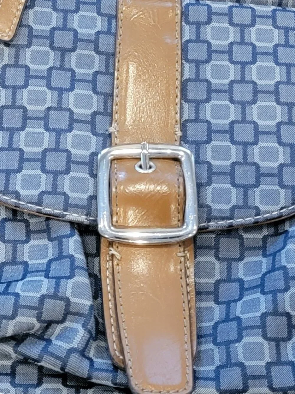 Nine West backpack purse featuring a geometric pattern and brown faux leather tr